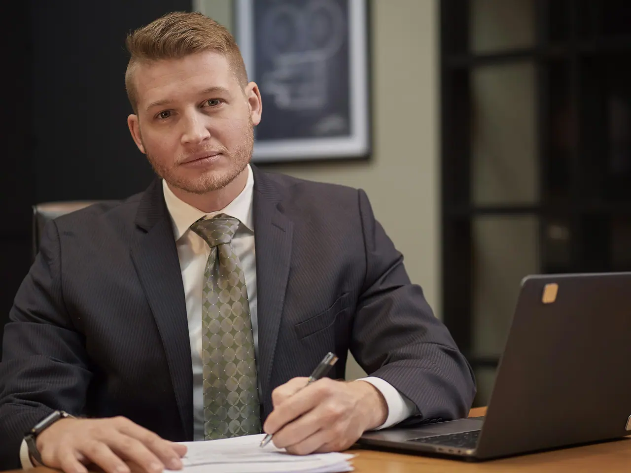 Portrait of a bearded attorney in a navy suit