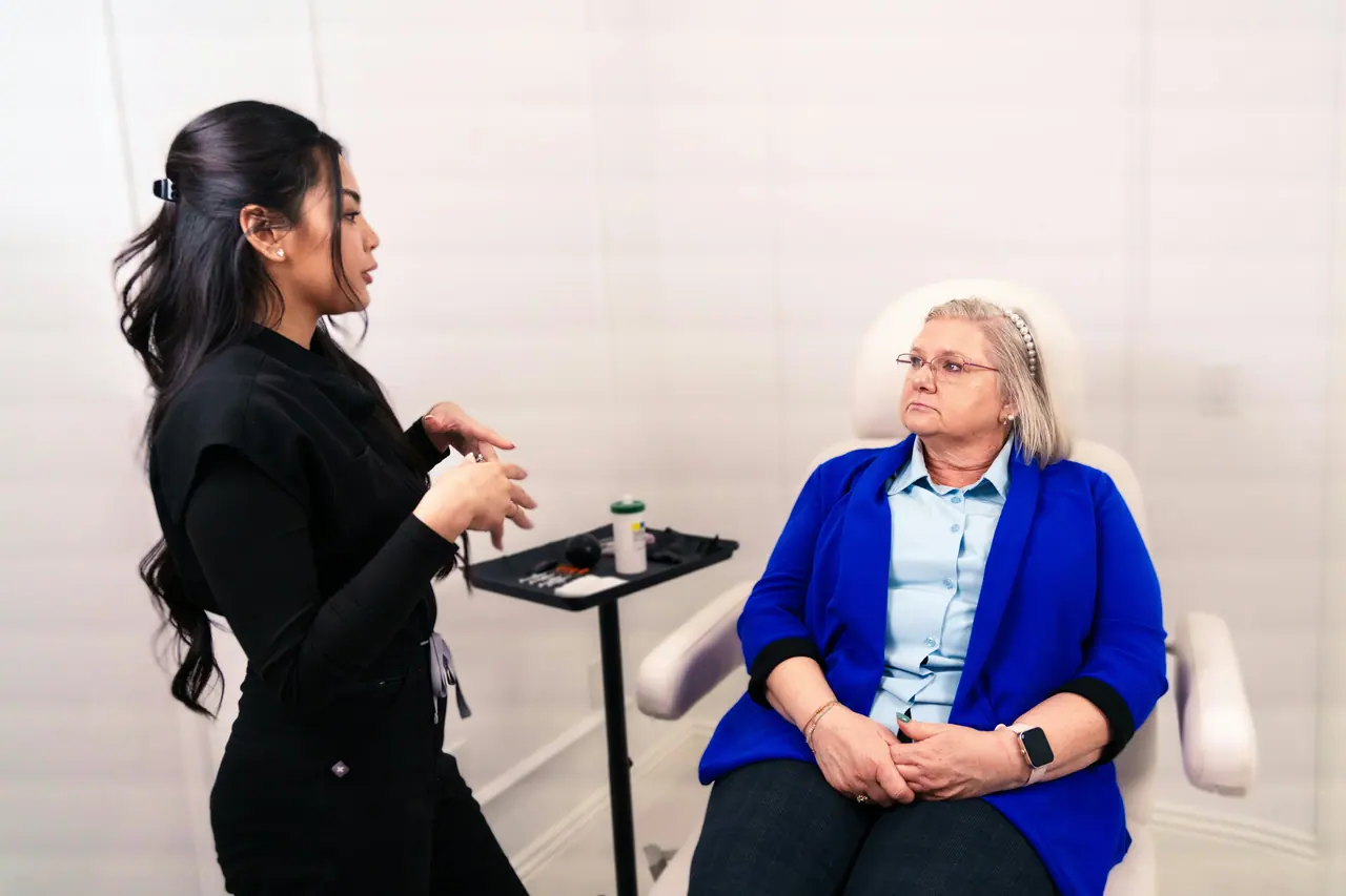 A provider in conversation with a seated client