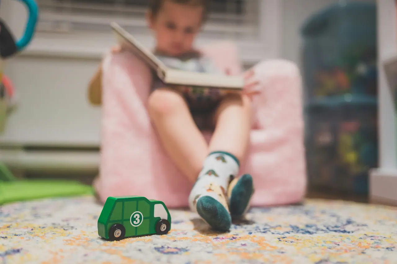 A child reading on a cushion
